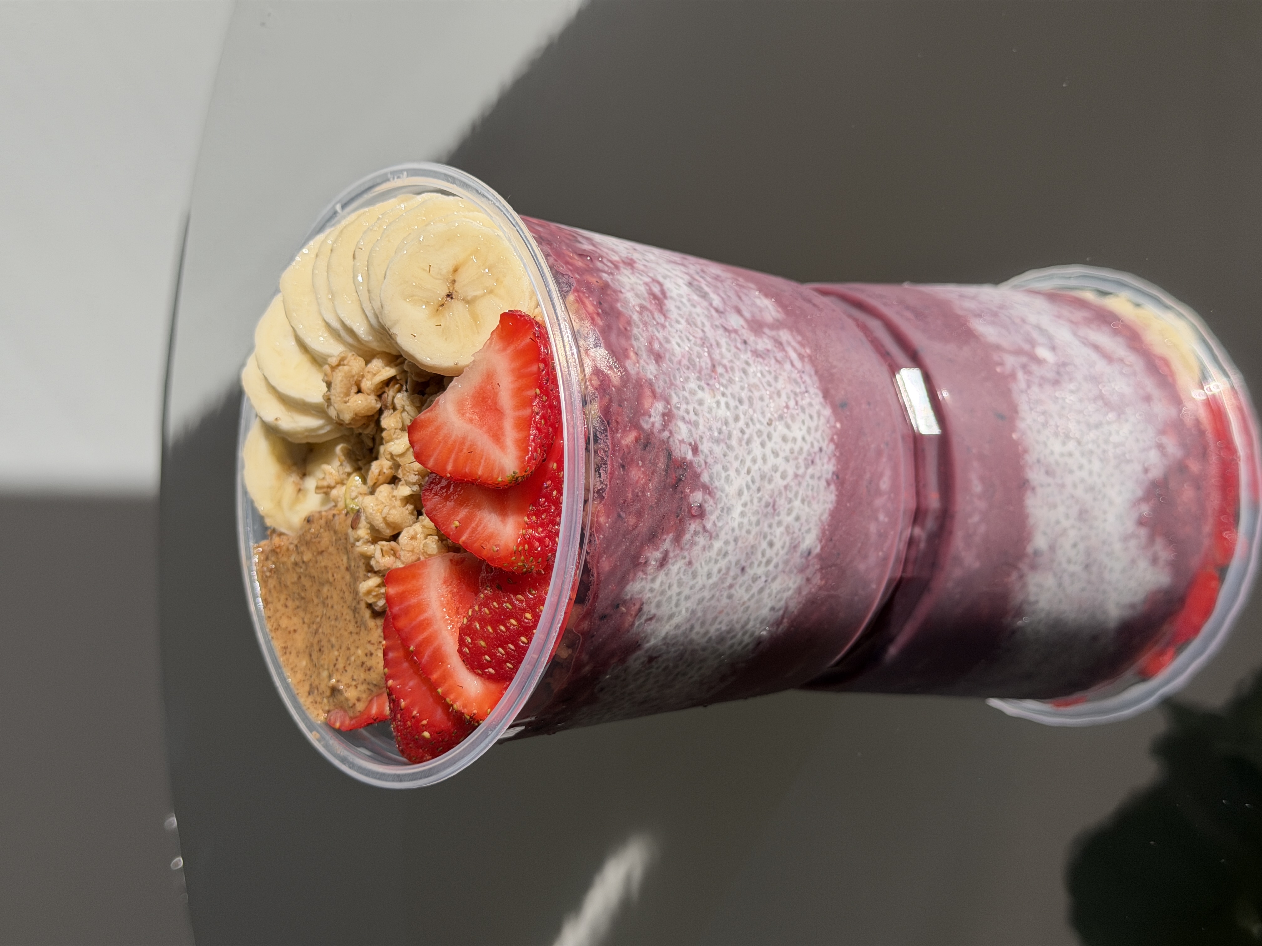 Layered açaí and chia bowl with strawberries, banana and granola