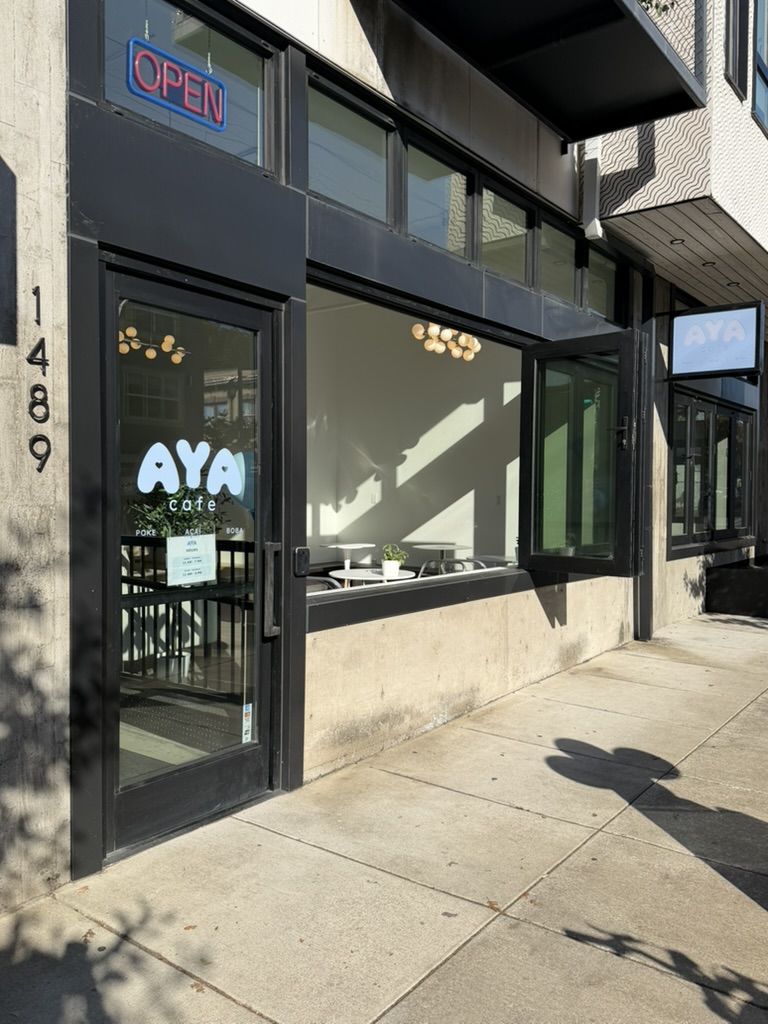 AYA Cafe storefront with its blue logo and open windows